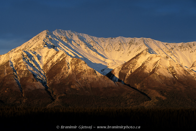 Snow covered mountain peak at sunrise, Auriol Range, Kluane National Park, Yukon Territory