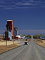 grain elevators and car on a gravel road, Kyle