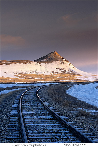 Train tracks and snow covered hills, Rockglen