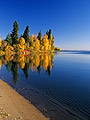 Autumn trees reflecting in lake, Smoothstone Lake, Saskatchewan