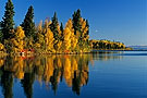 Autumn trees reflecting in lake, Smoothstone Lake, Saskatchewan