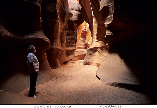 Man standing inside underground canyon, Antelope Canyon interior, Arizona